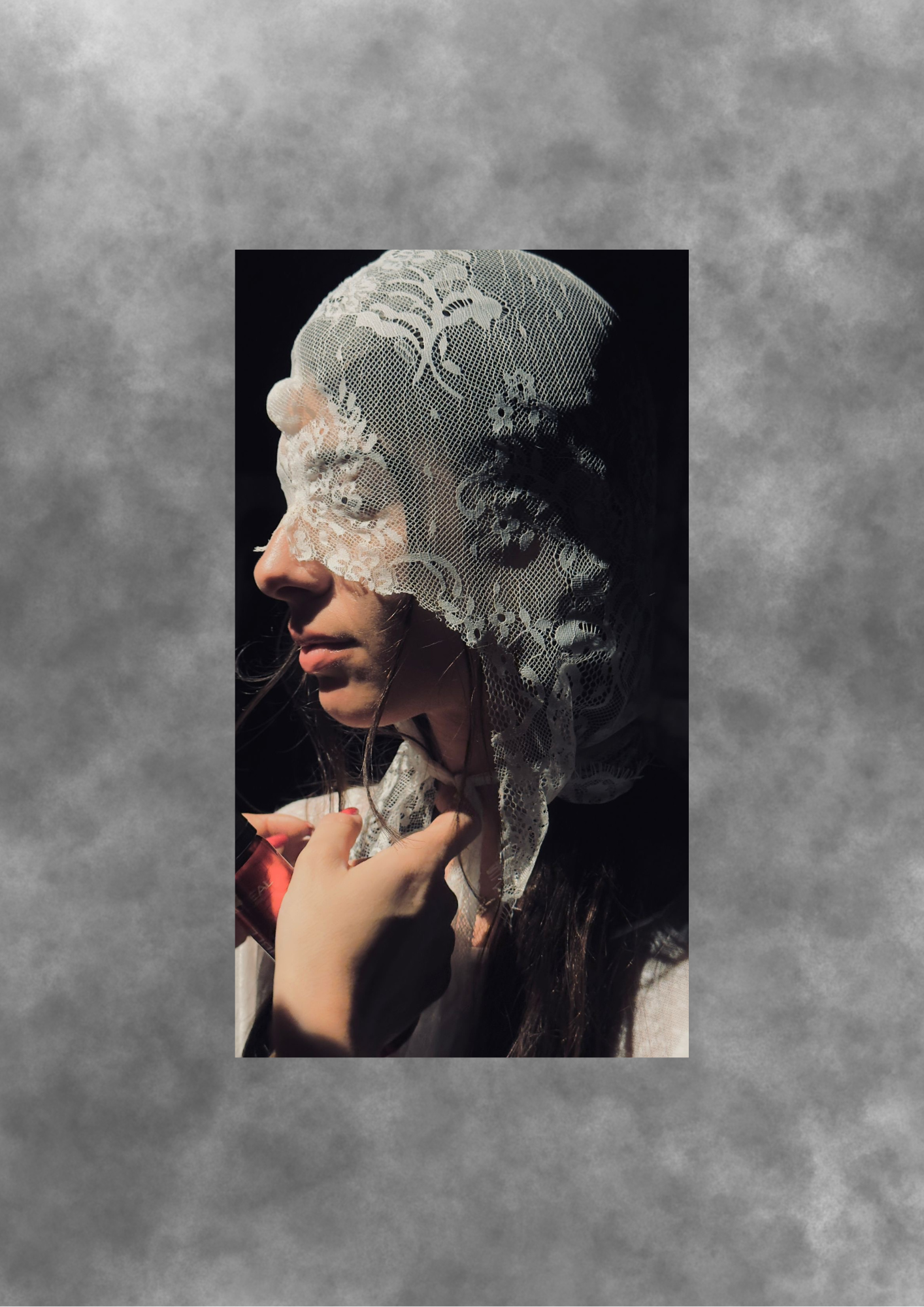 Portrait of a woman in a lace veil lit in profile.